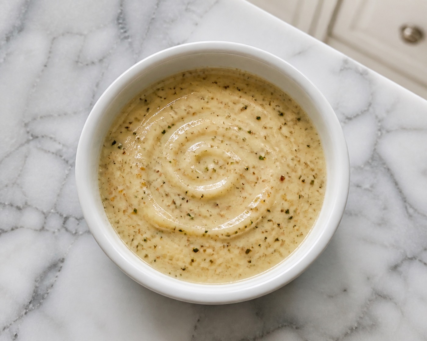 Esperanza House Dressing, photographed on white marble in the A More Perfect Supper kitchen