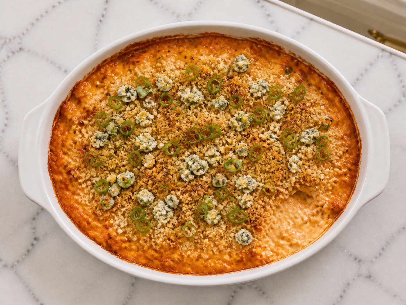 Buffalo Dip with a Crunch, photographed on white marble in the A More Perfect Supper kitchen