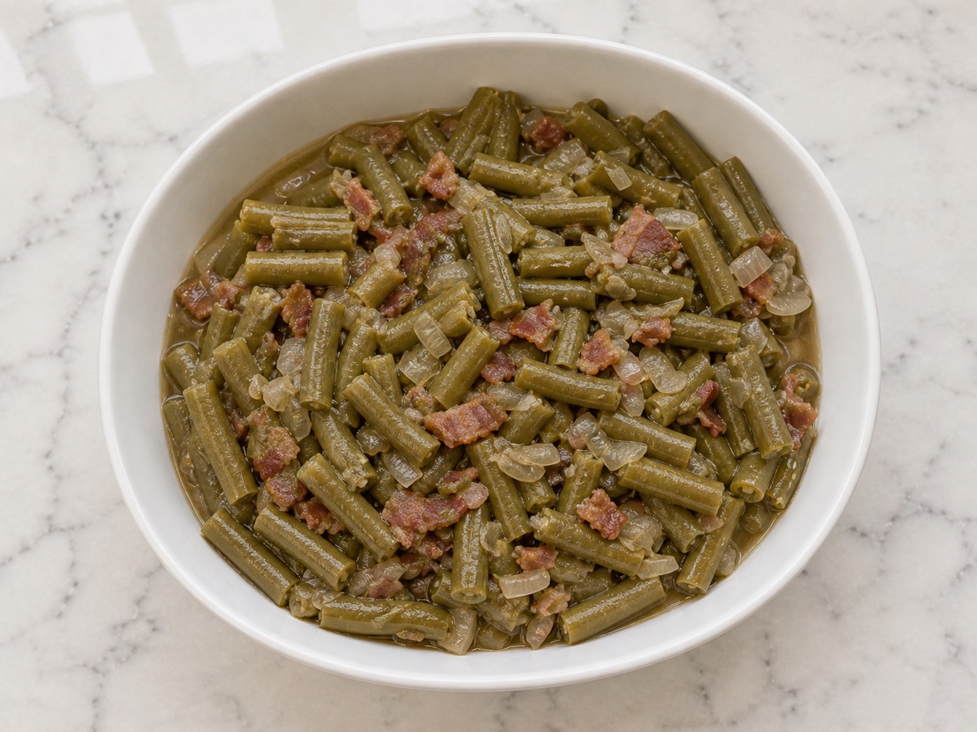 Low & Slow Southern Green Beans, photographed on white marble in the A More Perfect Supper kitchen