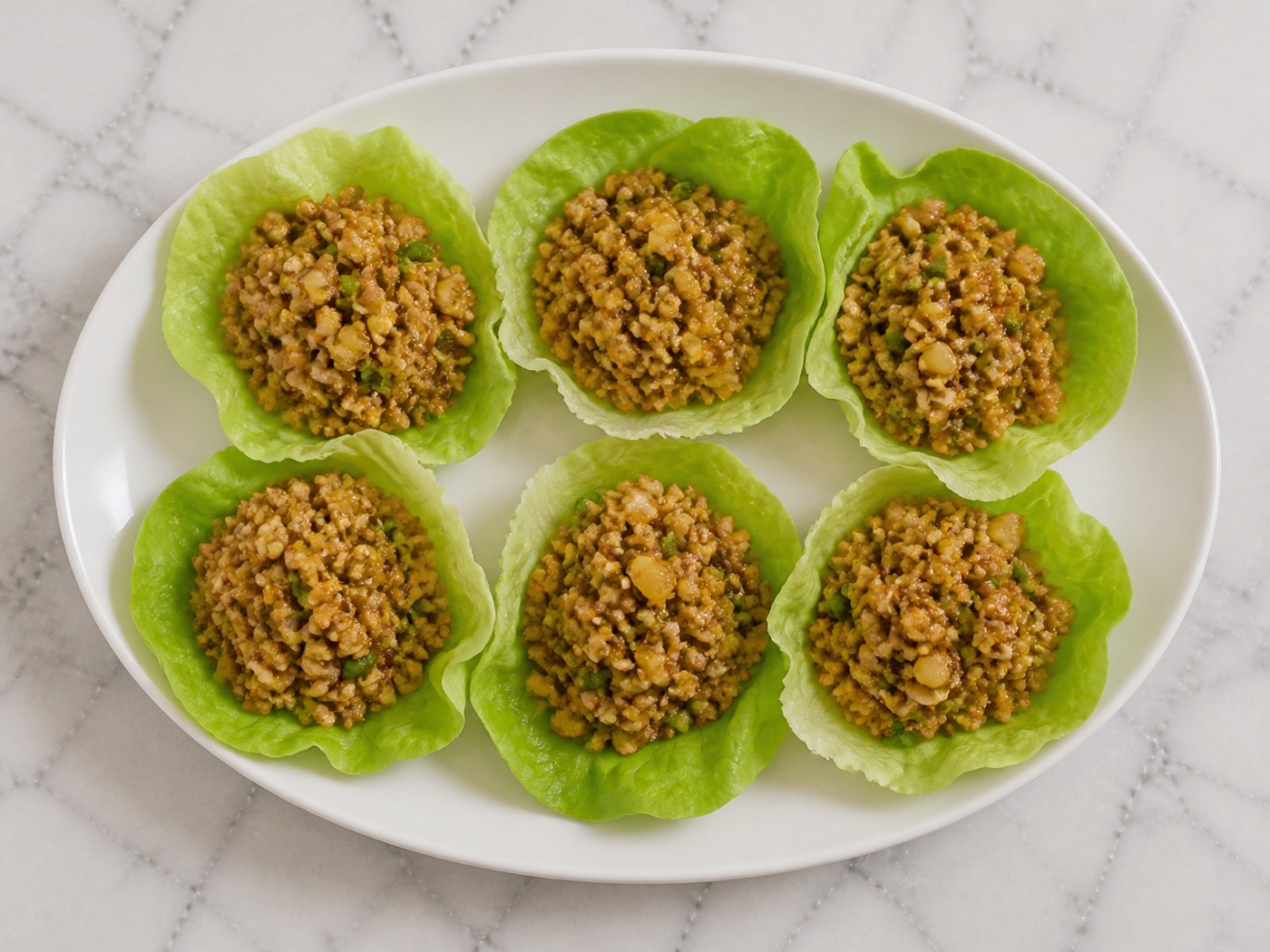 Chang's-Style Lettuce Wraps, photographed on white marble in the A More Perfect Supper kitchen
