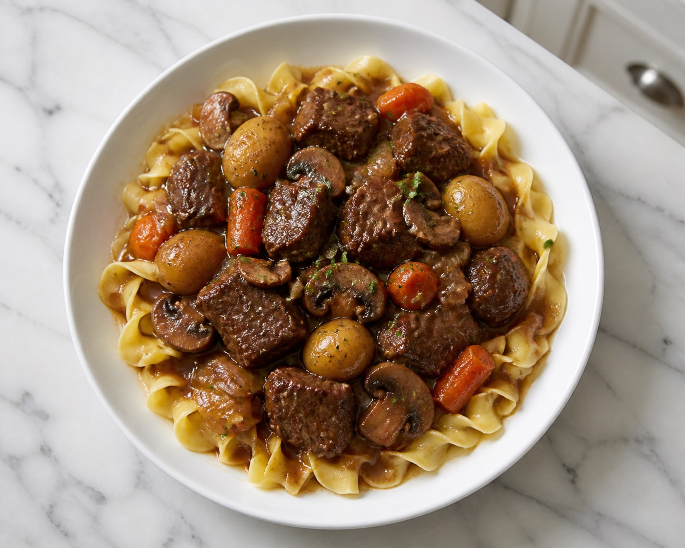 Sunday Pot Roast & Noodles, photographed on white marble in the A More Perfect Supper kitchen